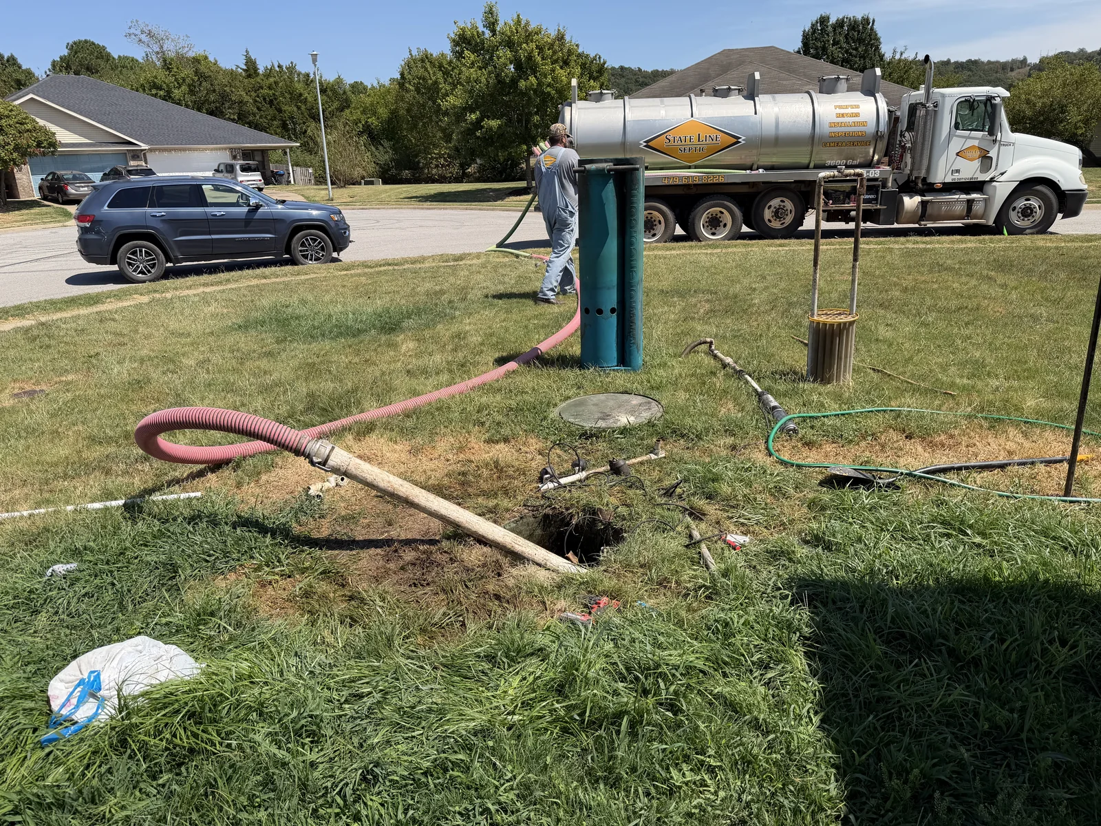 Septic service truck and pumping equipment at a job