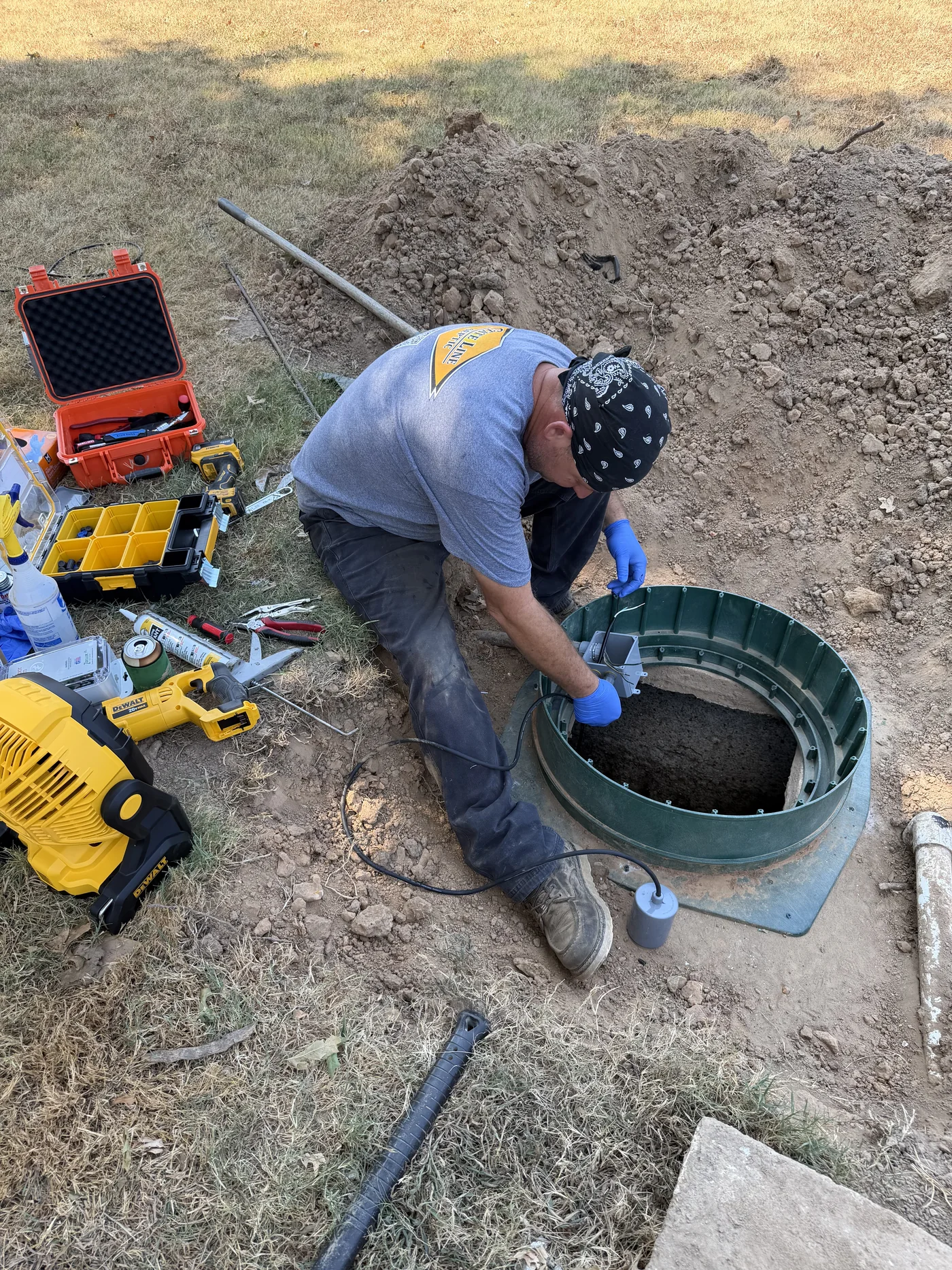 Technician servicing septic system components